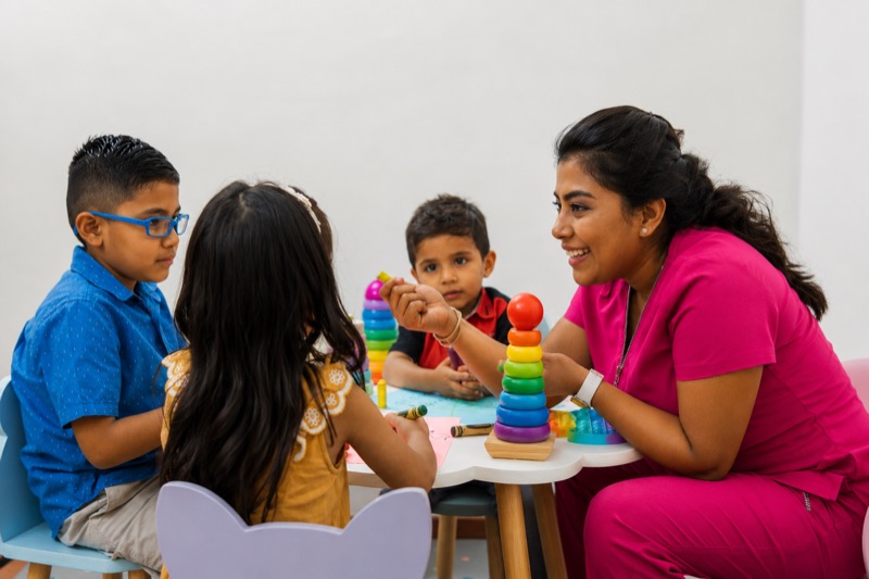 Therapist in a play-based therapy session with children